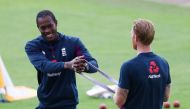 FILE PHOTO: Cricket - Third Test - England v West Indies - Emirates Old Trafford, Manchester, Britain - July 25, 2020 England's Jofra Archer and Ben Stokes warm up before the match, as play resumes behind closed doors following the outbreak of the coronav