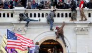FILE PHOTO: A mob of supporters of U.S. President Donald Trump fight with members of law enforcement at a door they broke open as they storm the U.S. Capitol Building in Washington, U.S., January 6, 2021. REUTERS/Leah Millis/File Photo