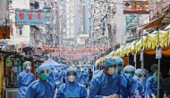Health workers are seen in protective gear inside a locked down portion of the Jordan residential area to contain a new outbreak of the coronavirus disease (COVID-19), in Hong Kong, China January 23, 2021. REUTERS/Tyrone Siu/File Photo