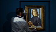 A worker at Sotheby's auctions takes Sandro Botticelli's 