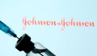 A vial and sryinge are seen in front of a displayed Johnson&Johnson logo in this illustration taken January 11, 2021. REUTERS/Dado Ruvic/Illustration/File Photo
