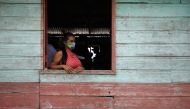 An Indigenous woman waits to receive the Sinovac's CoronaVac coronavirus disease (COVID-19) vaccine at Sao Jose Village in the Indigenous land Rio Urubu from the ethnicity Mura in the Urubu river banks in Itacoatiara, Amazonas state, Brazil, February 13, 