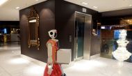 AI-powered robot Ariel stands outside a lift before delivering room service at the Hotel Sky, the first in Africa to use automated attendants, in Johannesburg, South Africa, February 9, 2021. Picture taken February 9, 2021. REUTERS/ Sumaya Hisham