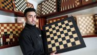 David Ferrer poses with a chessboard at the Rechapados Ferrer factory of which products have appeared in the Netflix series 