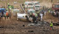 Rescuers and people gather near the debris from a Nigerian air force plane, which according to the aviation minister crashed while approaching the Abuja airport runway, in Abuja, Nigeria February 21, 2021. REUTERS/Afolabi Sotunde

