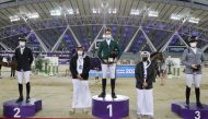 Omar Al Mannai, Event Director of Commercial Bank CHI Al Shaqab, and Bader Al Darwish, Secretary-General of Qatar and Asian Equestrian Federations and CHI Al Shaqab Organising Committee Member, posing for a photograph with the podium winners of the CSI5* 