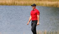 Feb 28, 2021; Bradenton, Florida, USA; Rory McIlroy walks to the second green wearing red and black honoring Tiger Woods during the final round of World Golf Championships at The Concession golf tournament at The Concession Golf Club. Mandatory Credit: Mi