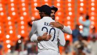 India's captain Virat Kohli hugs his teammate Axar Patel after they beat England. REUTERS/Amit Dave