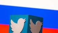 A 3D-printed Twitter logo is pictured in front of a displayed Russian flag in this illustration taken March 10, 2021. REUTERS/Dado Ruvic/Illustration