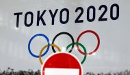 The logo of Tokyo 2020 Olympic Games that have been postponed to 2021 due to the coronavirus disease (COVID-19) outbreak, is seen through a traffic sign at Tokyo Metropolitan Government Office building in Tokyo, Japan January 22, 2021. REUTERS/Issei Kato/