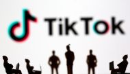 Small toy figures are seen in front of TikTok logo in this illustration picture taken March 15, 2021. REUTERS/Dado Ruvic/Illustration
