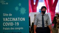 FILE PHOTO: Canadian Prime Minister Justin Trudeau visits a vaccination clinic at the Palais des Congres, as efforts continue to help slow the spread of the coronavirus disease (COVID-19), in Montreal, Quebec, Canada March 15, 2021. REUTERS/Andrej Ivanov/