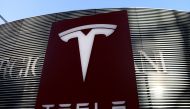 File photo: A logo of the electric vehicle maker Tesla is seen near a shopping complex in Beijing, China January 5, 2021. Reuters /Tingshu Wang/File Photo