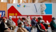 FILE PHOTO: People wait in a COVID-19 vaccination centre, as Portugal resumes vaccination with AstraZeneca shots after a temporary suspension, amid the coronavirus disease (COVID-19) pandemic, in Seixal, Portugal, March 22, 2021. REUTERS/Pedro Nunes/File 