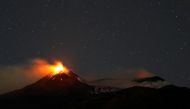 FILE PHOTO: Large streams of red hot lava shoot into the night sky as Mount Etna seen from the village of Fornazzo, Italy, February 3. REUTERS/Antonio Parrinello


