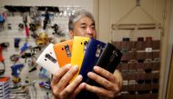 Ryu Hyun-soo, 53, holds his LG smartphones in Anyang, South Korea April 12, 2021. Picture taken April 12, 2021. REUTERS/Daewoung Kim
