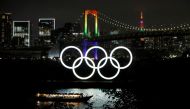 The Rainbow Bridge and Tokyo Tower are illuminated with Olympic colours to mark 100 days countdown to the Tokyo 2020 Olympics that have been postponed to 2021 due to the coronavirus disease (COVID-19) outbreak, in Tokyo, Japan April 14, 2021. REUTERS/Isse
