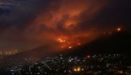 Flames are seen close to the city fanned by strong winds after a bushfire broke out on the slopes of Table Mountain in Cape Town, South Africa, on April 19, 2021. Reuters/Mike Hutchings