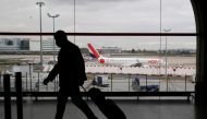 A man walks through a terminal at Paris Charles de Gaulle airport near Paris, February 5, 2021. REUTERS/Gonzalo Fuentes/File Photo