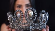 A staff holds a diamond and pearl tiara passed down through generations of the Italian royal family during a preview at Sotheby's before their auction in Geneva, Switzerland, May 6, 2021. REUTERS/Denis Balibouse