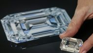 A staff holds a D colour, internally flawless rectangular step-cut diamond of 100.94 carats during a preview at Christie's before its auction sale in Geneva, Switzerland, May 7, 2021. REUTERS/Denis Balibouse