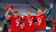 Bayern Munich's Thomas Muller, Manuel Neuer and Robert Lewandowski celebrate after the match after winning the Bundesliga. (REUTERS/Christof Stache)