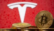 FILE PHOTO: Representations of virtual currency Bitcoin are seen in front of Tesla logo in this illustration taken, February 9, 2021. REUTERS/Dado Ruvic/File Photo/File Photo
