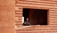 Nzinga Mboup, an architect and co-founder of the Collectif Worofila, an architecture workshop that specialises in bioclimatic architecture and the implementation of organically sourced materials, speaks as she stands at the window of the house under const