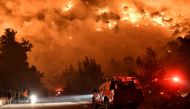 Flames rise as firefighters and volunteers try to extinguish a fire burning in the village of Schinos, near Corinth, Greece, May 19, 2021. Picture taken May 19, 2021. REUTERS/Vassilis Psomas TPX IMAGES OF THE DAY

