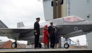 Captain Angus Essenhigh and Commodore Steve Moorhouse are seen with Britain's Queen Elizabeth during Her visit to the Royal Navy aircraft carrier HMS Queen Elizabeth at HM Naval Base in Portsmouth, Britain May 22, 2021. Steve Parsons/PA Wire/Pool via REUT