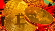 :Representations of the virtual currency Bitcoin and Ethereum stand on a motherboard in this picture illustration taken May 20, 2021. (REUTERS)