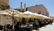 FILE PHOTO: People sit at an outdoor restaurant as restaurants and markets reopened for business after coronavirus disease (COVID-19) vaccinations reached 60% of the adult population, in Valletta, Malta May 10, 2021. REUTERS/Darrin Zammit Lupi/File Photo