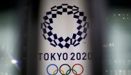 The logo of Tokyo 2020 Olympic Games that have been postponed to 2021 due to the coronavirus disease (COVID-19) outbreak, is seen through signboards, at Tokyo Metropolitan Government Office building in Tokyo, Japan January 22, 2021. REUTERS/Issei Kato/Fil