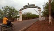 A man rides a motorcycle as he drives past the entrance of the Malian army force base where military detain Mali's President Bah Ndaw, Prime Minister Moctar Ouane and defence minister Souleymane Doucoure in Kati, Mali May 25, 2021. Reuters/Amadou Keita