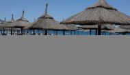 Unoccupied beach lounge chairs are seen on a half empty beach by the Mediterranean Sea, amid the coronavirus disease (COVID-19) pandemic, in Fuengirola, southern Spain, May 25, 2021. REUTERS/Jon Nazca

