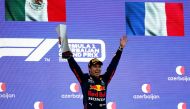 Red Bull's Sergio Perez celebrates with a trophy on the podium after winning the race Pool via REUTERS/Maxim Shemetov