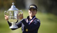 Yuka Saso hoists the US Open trophy after winning in a sudden death playoff over Nasa Hataoka following the final round of the U.S. Women's Open golf tournament at The Olympic Club. Mandatory Credit: Kelvin Kuo-USA TODAY Sports