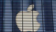 The Apple logo is seen through a security fence erected around the Apple Fifth Avenue store. Reuters/Andrew Kelly/File Photo