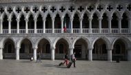 People walk carrying their luggage as the region of Veneto becomes a 