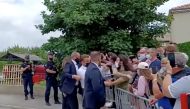 French President Emmanuel Macron gets slapped by a member of the public during a visit in Tain-L'Hermitage, France, in this still image taken from video on June 8, 2021. BFMTV/ReutersTV
