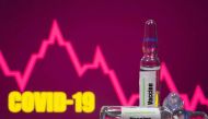 FILE PHOTO: A test tube labelled with the Vaccine is seen in front of Covid-19 and stock graph logo in this illustration taken, September 9, 2020. REUTERS/Dado Ruvic/Illustration/File Photo
