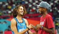 Qatar's Mutaz Essa Barshim talks with Italy's Gianmarco Tamberi during the World Athletics Championships in Doha in this file photo.
