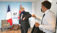 Britain's Prime Minister Boris Johnson and France's President Emmanuel Macron elbow bump as they attend a bilateral meeting during G7 summit in Carbis Bay, Cornwall, Britain, June 12, 2021. (REUTERS)