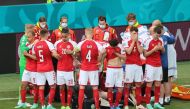 Denmark players react as Christian Eriksen receives medical attention after collapsing during the match Pool via REUTERS/Wolfgang Rattay
