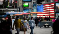 FILE PHOTO:People make their way through Times Square, amid the coronavirus disease (COVID-19) pandemic, in Manhattan, New York City, U.S., May 07, 2021. REUTERS/Eduardo Munoz/File Photo
