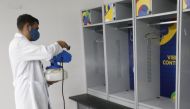 A staff member disinfects the dressing rooms at the Arena. (REUTERS/Mariana Greif)