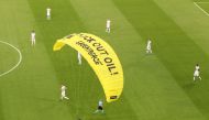  A Greenpeace protestor glides onto the pitch before the match Pool via Reuters/Alexander Hassenstein
