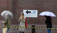 People queue in the rain to receive a COVID-19 vaccination amid the spread of the coronavirus disease pandemic, London, Britain, June 18, 2021. Reuters/Toby Melville