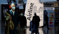 Travellers walk with their luggage at Fiumicino Airport... Reuters/Remo Casilli/File Photo