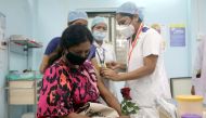 A healthcare worker holding a rose receives an AstraZeneca's COVISHIELD vaccine at a medical centre in Mumbai, India, January 16, 2021. Reuters/Francis Mascarenhas/File Photo